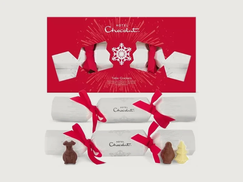 Hotel Chocolat table crackers in a red box, with two white crackers and chocolate figures