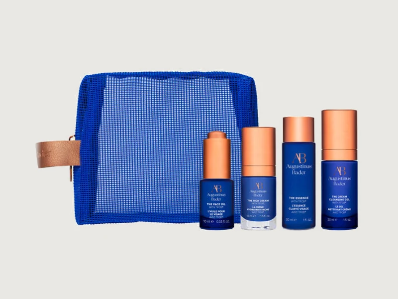 Augustinus Bader travel set of four skincare minis with a blue mesh bag