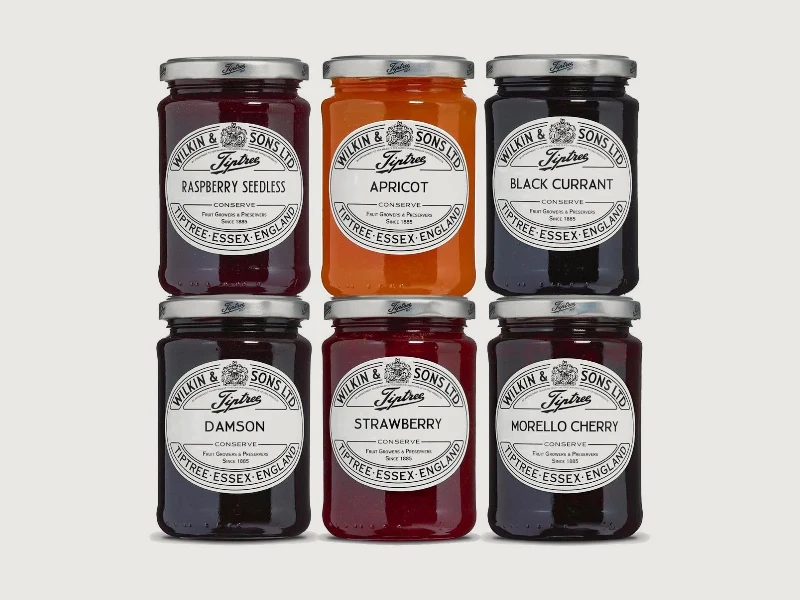 Six jars of Tiptree conserve: raspberry seedless, apricot, blackcurrant, damson, strawberry and morello cherry