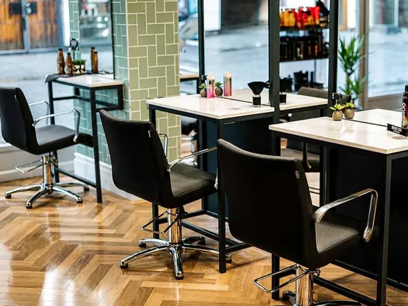 Styling chairs and mirrored stations on the parquet floor at North 36
